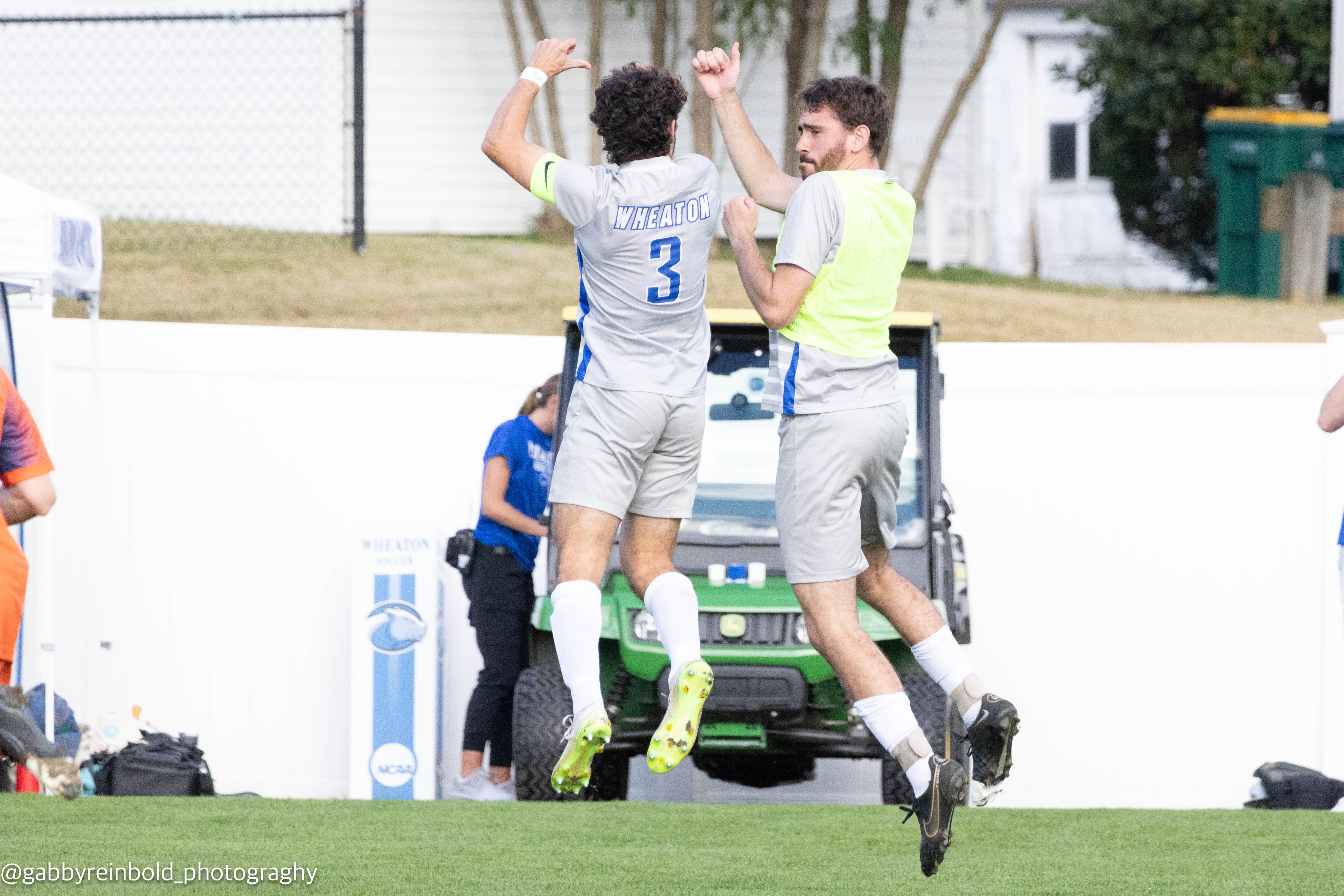 Two players jumping up into each others shoulders