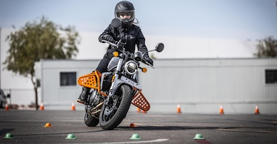 Motorcyclist on a safety course, winding through cones.